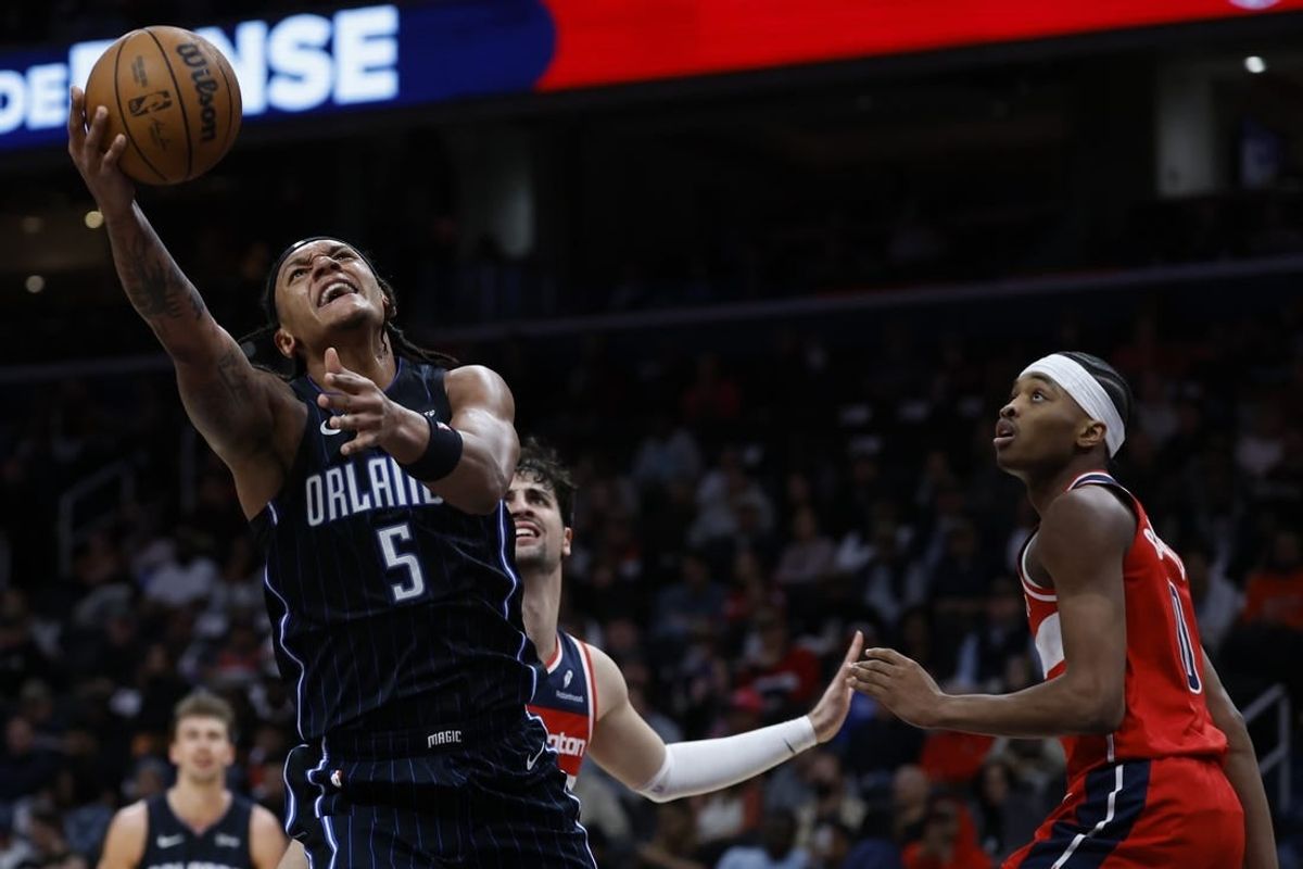 Mar 6, 2024; Washington, District of Columbia, USA; Orlando Magic forward Paolo Banchero (5) shoots the ball as Washington Wizards guard Bilal Coulibaly (0) looks on in the first half at Capital One Arena.