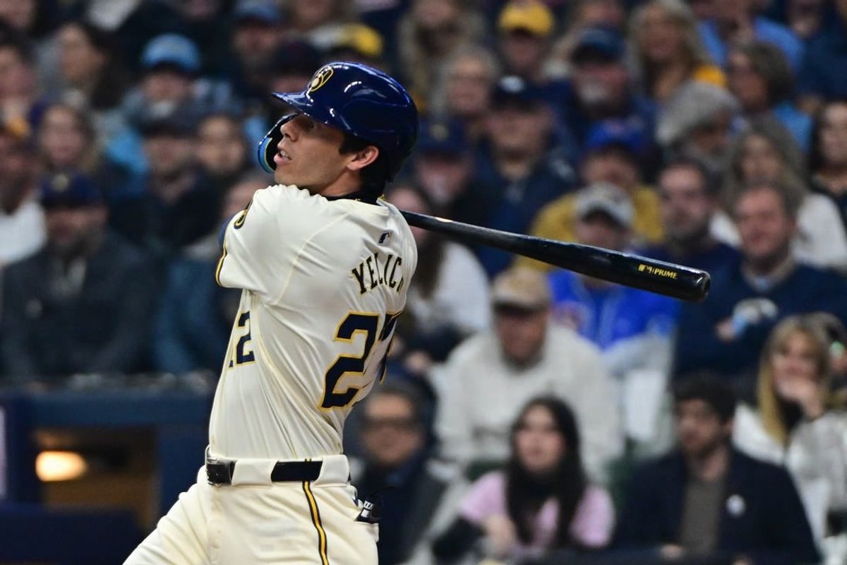 Apr 2, 2024; Milwaukee, Wisconsin, USA; Milwaukee Brewers left fielder Christian Yelich (22) hits a solo home run in the third inning against the Minnesota Twins at American Family Field.