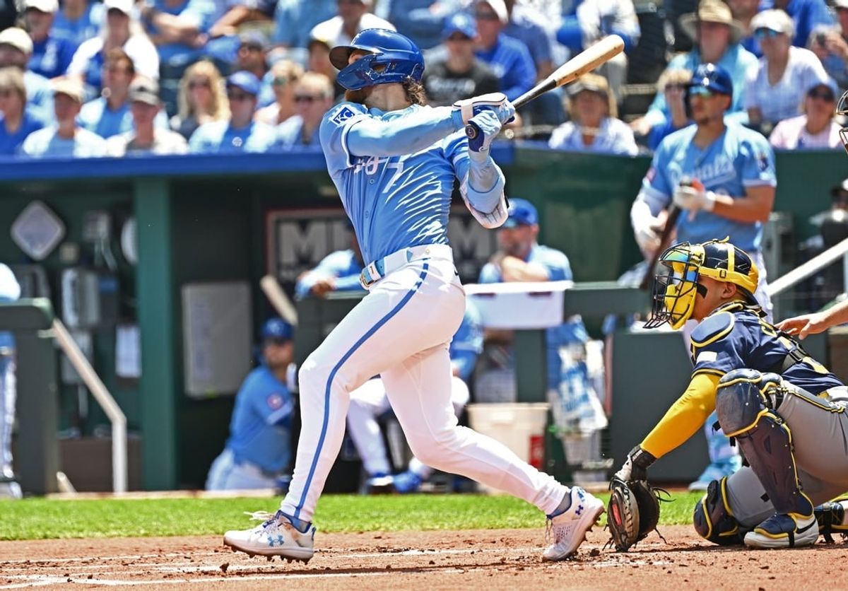 May 8, 2024; Kansas City, Missouri, USA;  Kansas City Royals shortstop Bobby Witt Jr. (7) doubles in the first inning against the Milwaukee Brewers at Kauffman Stadium.
