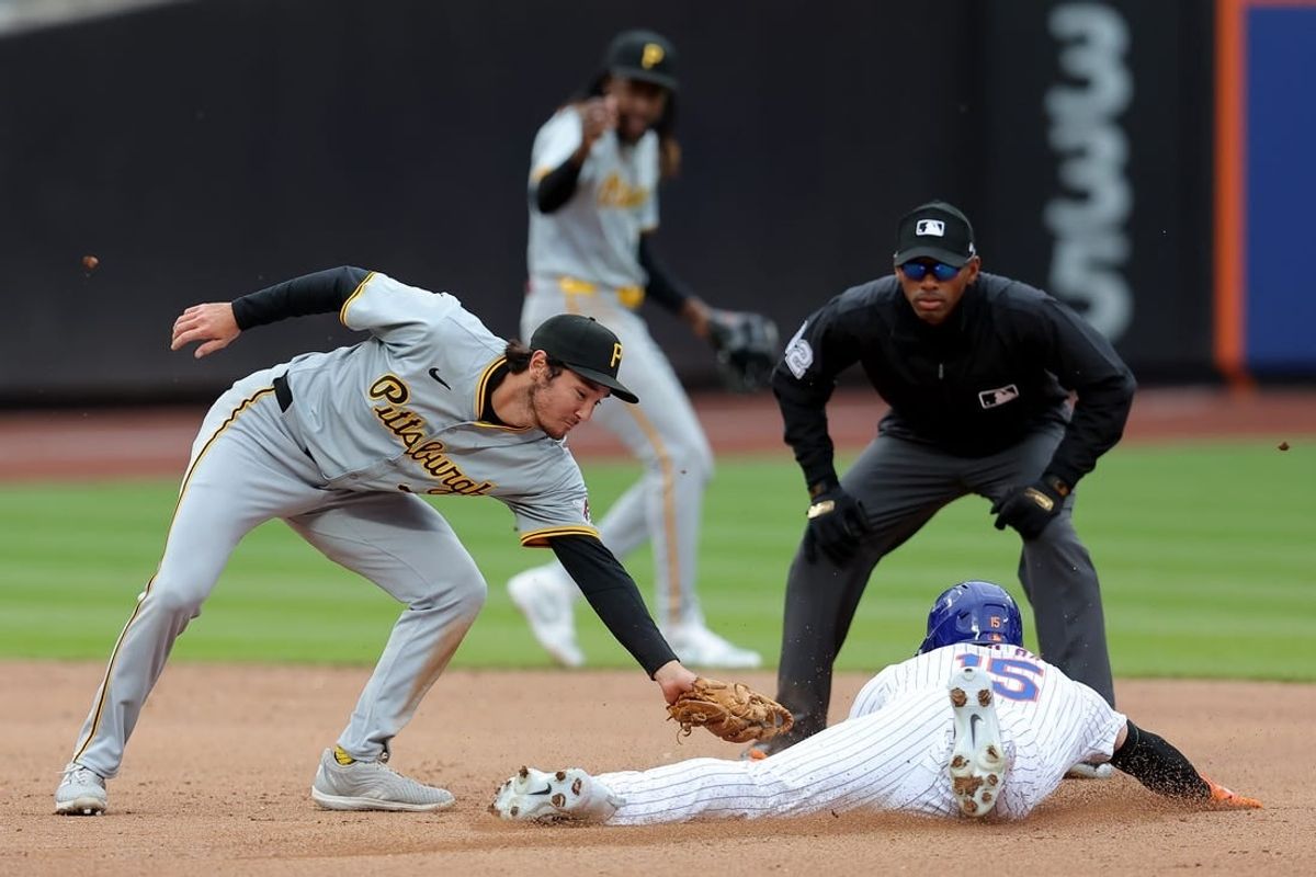 Apr 17, 2024; New York City, New York, USA; New York Mets right fielder Tyrone Taylor (15) steals second base ahead of the tag by Pittsburgh Pirates second baseman Alika Williams (25) during the fourth inning at Citi Field.