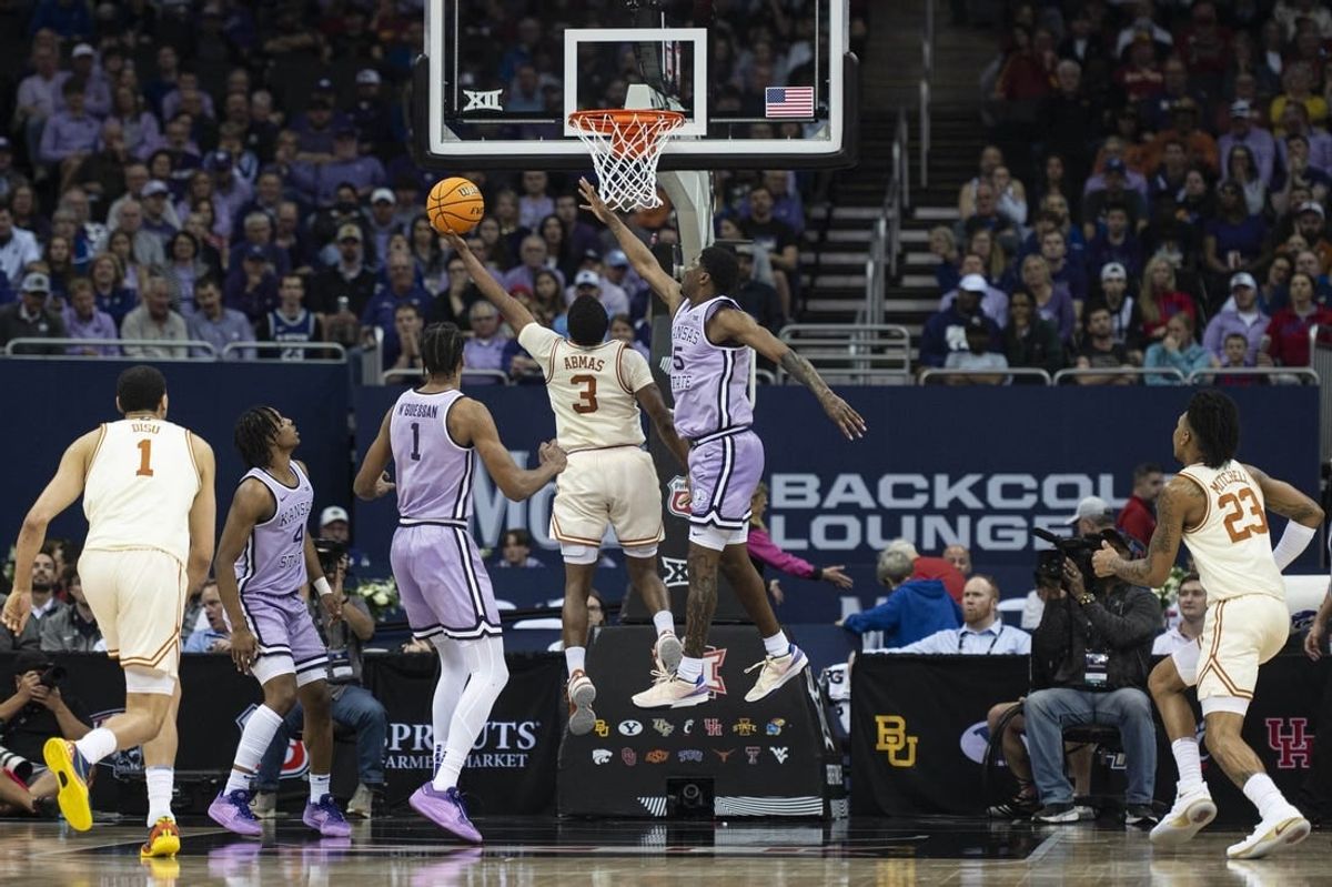 Mar 13, 2024; Kansas City, MO, USA; Texas Longhorns guard Max Abmas (3) shoots the ball while defended by Kansas State Wildcats guard Cam Carter (5) during the first half at T-Mobile Center.