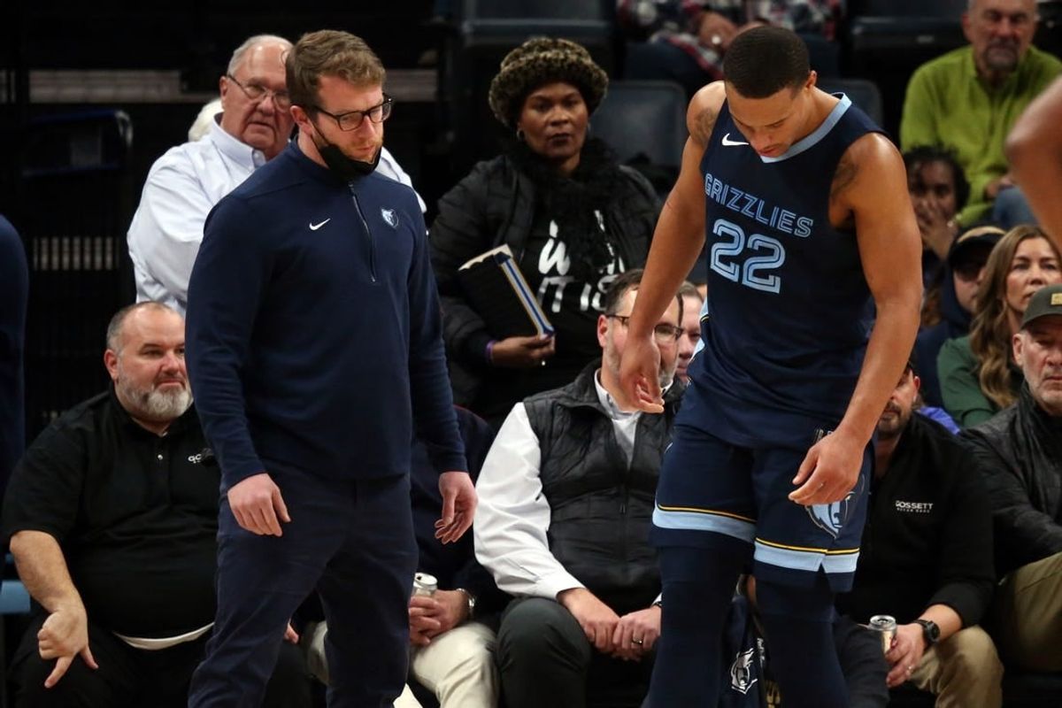 Jan 12, 2024; Memphis, Tennessee, USA; Memphis Grizzlies guard Desmond Bane (22) is checked by medical staff and would leave the game after a fall during the second half against the Los Angeles Clippers at FedExForum.