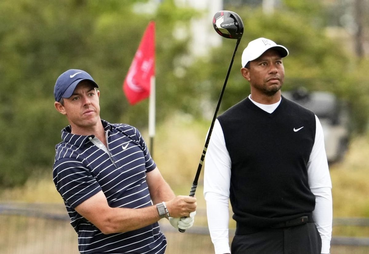 Jul 11, 2022; St. Andrews, SCT; Rory McIlroy and Tiger Woods during the R&A Celebration of Champions four-hole challenge at the 150th Open Championship golf tournament at St. Andrews Old Course.