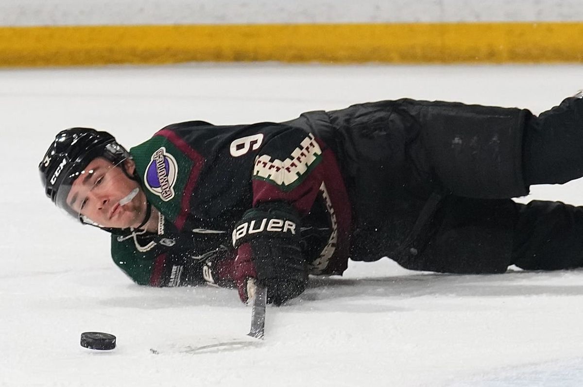 Mar 16, 2024; Tempe, Arizona, USA; Arizona Coyotes right wing Clayton Keller (9) moves the puck from the ice against the New Jersey Devils during the first period at Mullett Arena.