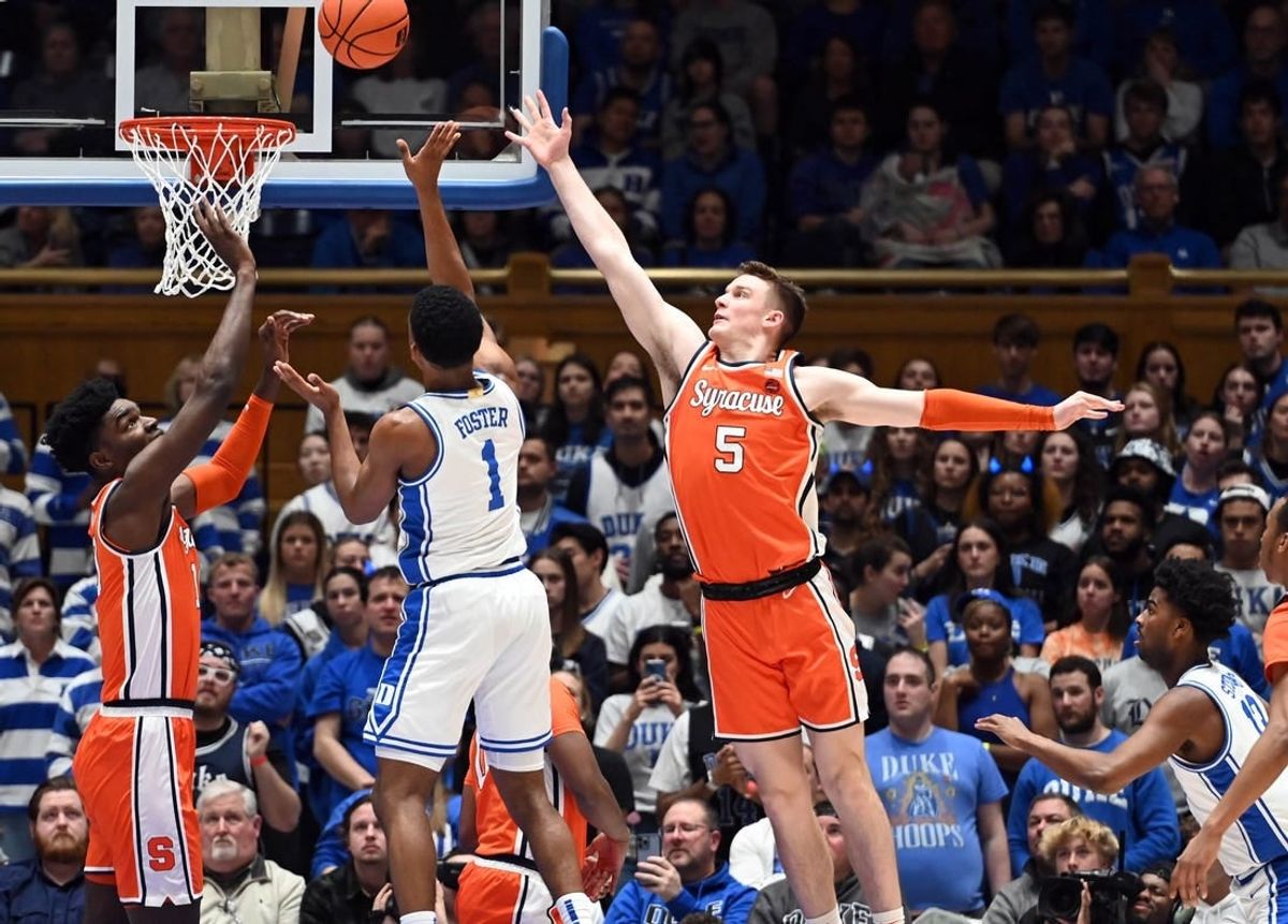 Jan 2, 2024; Durham, North Carolina, USA; Duke Blue Devils guard Caleb Foster (1) shoots between Syracuse Orange guard Justin Taylor (5) and center Naheem McLeod (10) during the first half at Cameron Indoor Stadium.