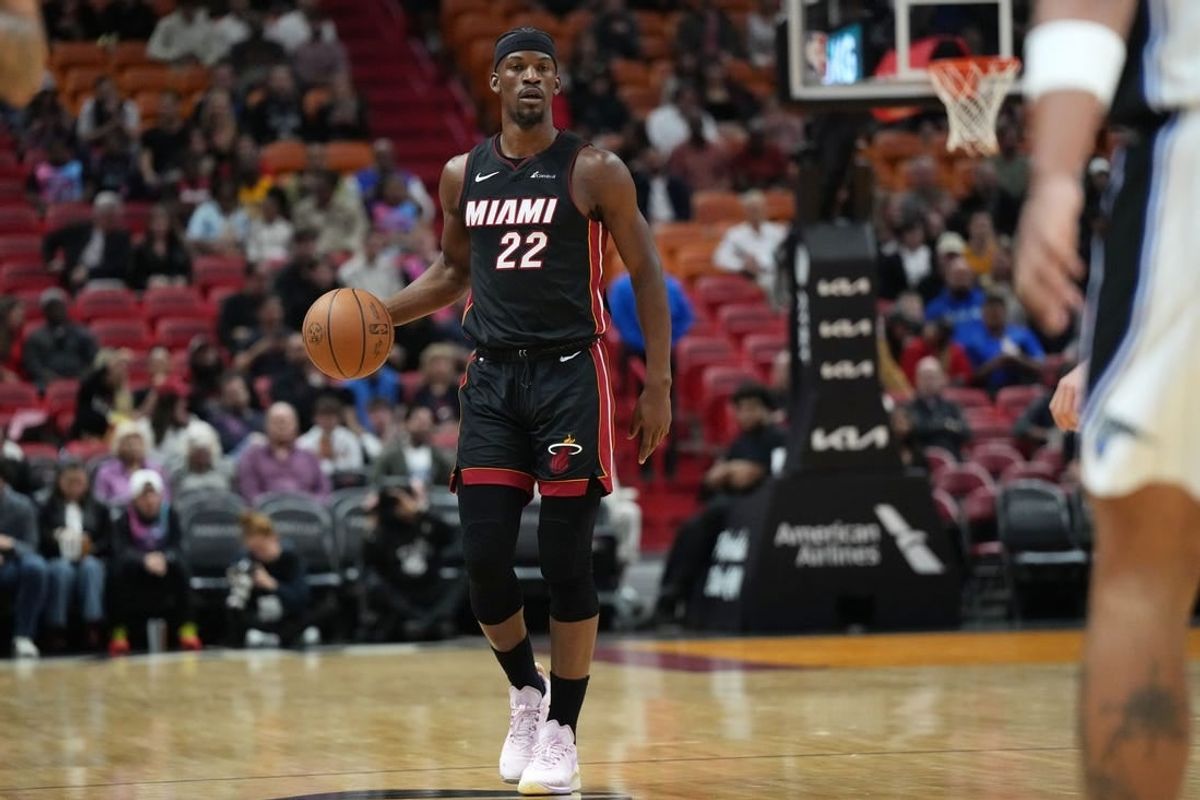 Feb 6, 2024; Miami, Florida, USA;  Miami Heat forward Jimmy Butler (22) brings the ball up the court against the Orlando Magic during the first half at Kaseya Center.