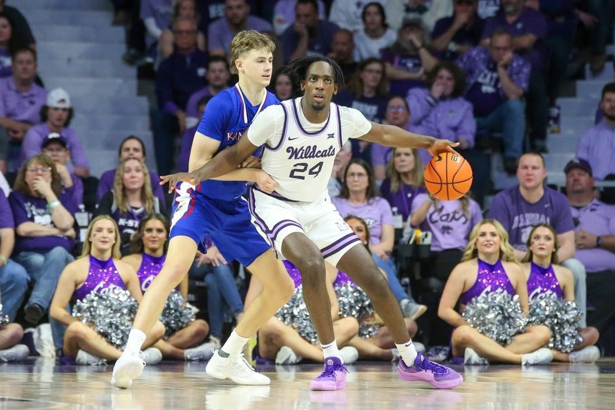 Feb 5, 2024; Manhattan, Kansas, USA; Kansas State Wildcats forward Arthur Maluma (24) is guarded by Kansas Jayhawks guard Johnny Furphy (10) during the second half at Bramlage Coliseum.