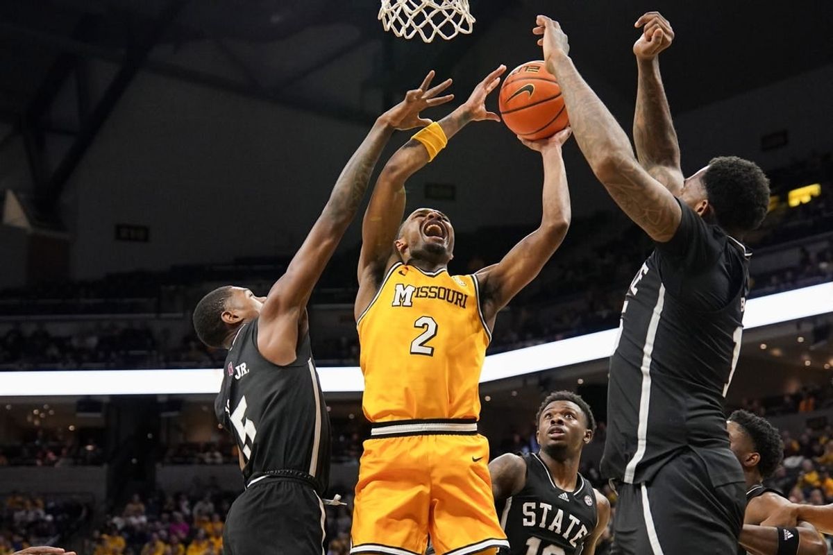 Feb 10, 2024; Columbia, Missouri, USA; Missouri Tigers guard Tamar Bates (2) shoots and is fouled by Mississippi State Bulldogs guard Shawn Jones Jr. (5) during the first half at Mizzou Arena.