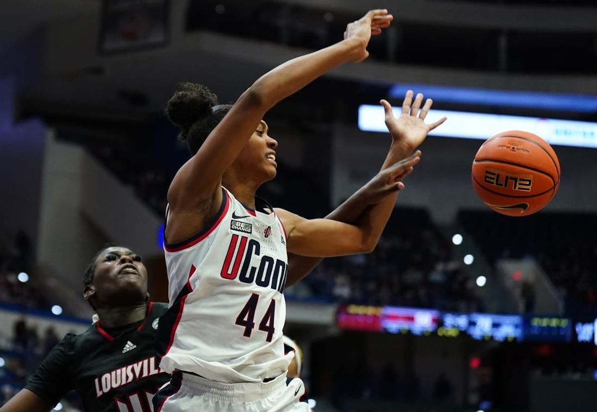 Dec 16, 2023; Hartford, Connecticut, USA; UConn Huskies guard Aubrey Griffin (44) is fouled by Louisville Cardinals forward Olivia Cochran (44) in the second half at XL Center.