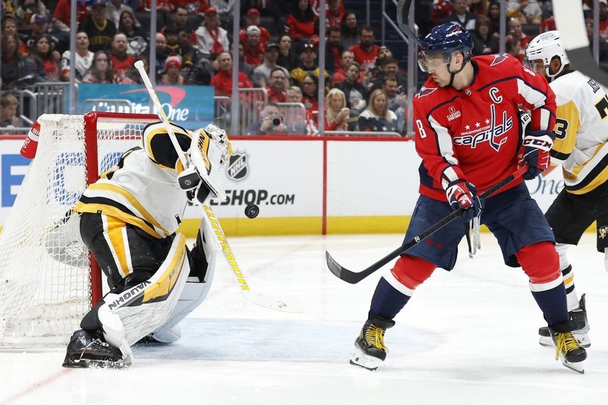 Apr 4, 2024; Washington, District of Columbia, USA; Pittsburgh Penguins goaltender Alex Nedeljkovic (39) makes a save in front of Washington Capitals left wing Alex Ovechkin (8) /in the third period at Capital One Arena.
