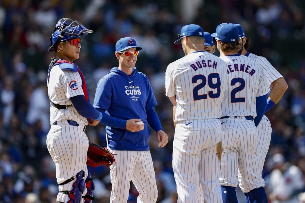May 3, 2024; Chicago, Illinois, USA; Chicago Cubs manager Craig Counsell (2-L) chats with his players during a pitching change during the eight inning of a baseball game against the Milwaukee Brewers at Wrigley Field.