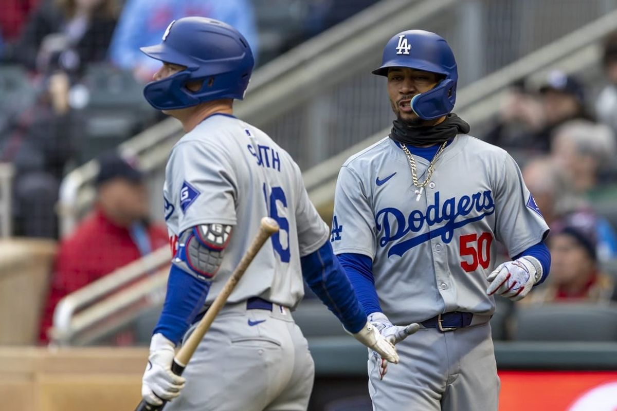 Apr 8, 2024; Minneapolis, Minnesota, USA; Los Angeles Dodgers shortstop Mookie Betts (50) celebrates with catcher Will Smith (16) after scoring a run against the Minnesota Twins in the first inning at Target Field.