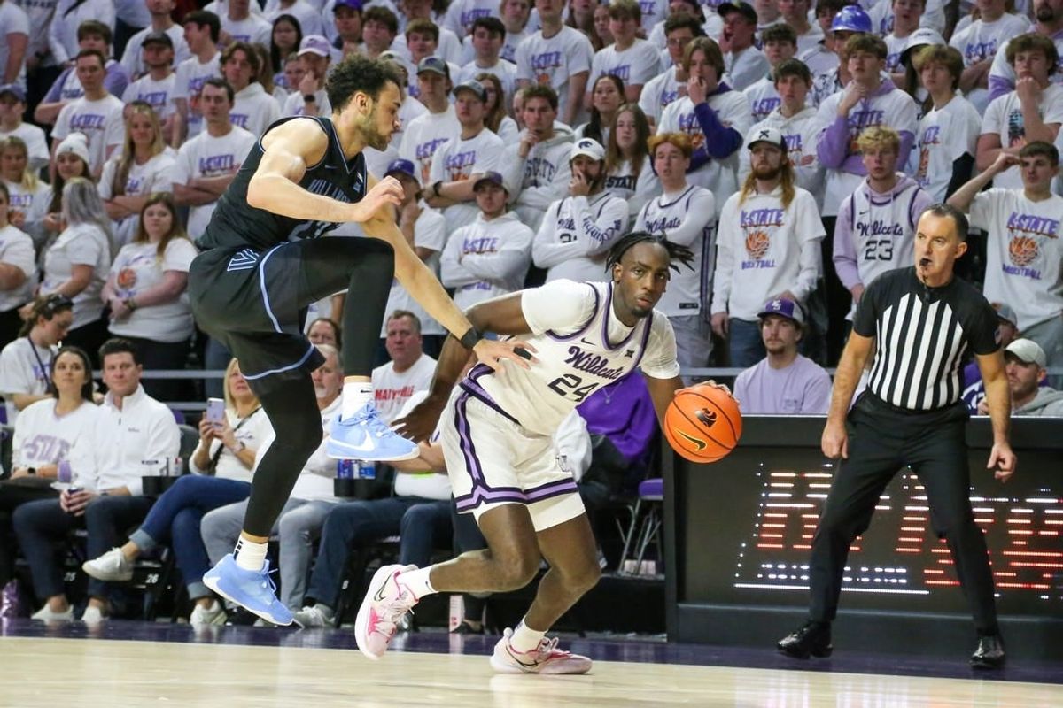 Dec 5, 2023; Manhattan, Kansas, USA; Kansas State Wildcats forward Arthur Maluma (24) dribbles by Villanova Wildcats forward Tyler Burton (23) during the first half at Bramlage Coliseum.