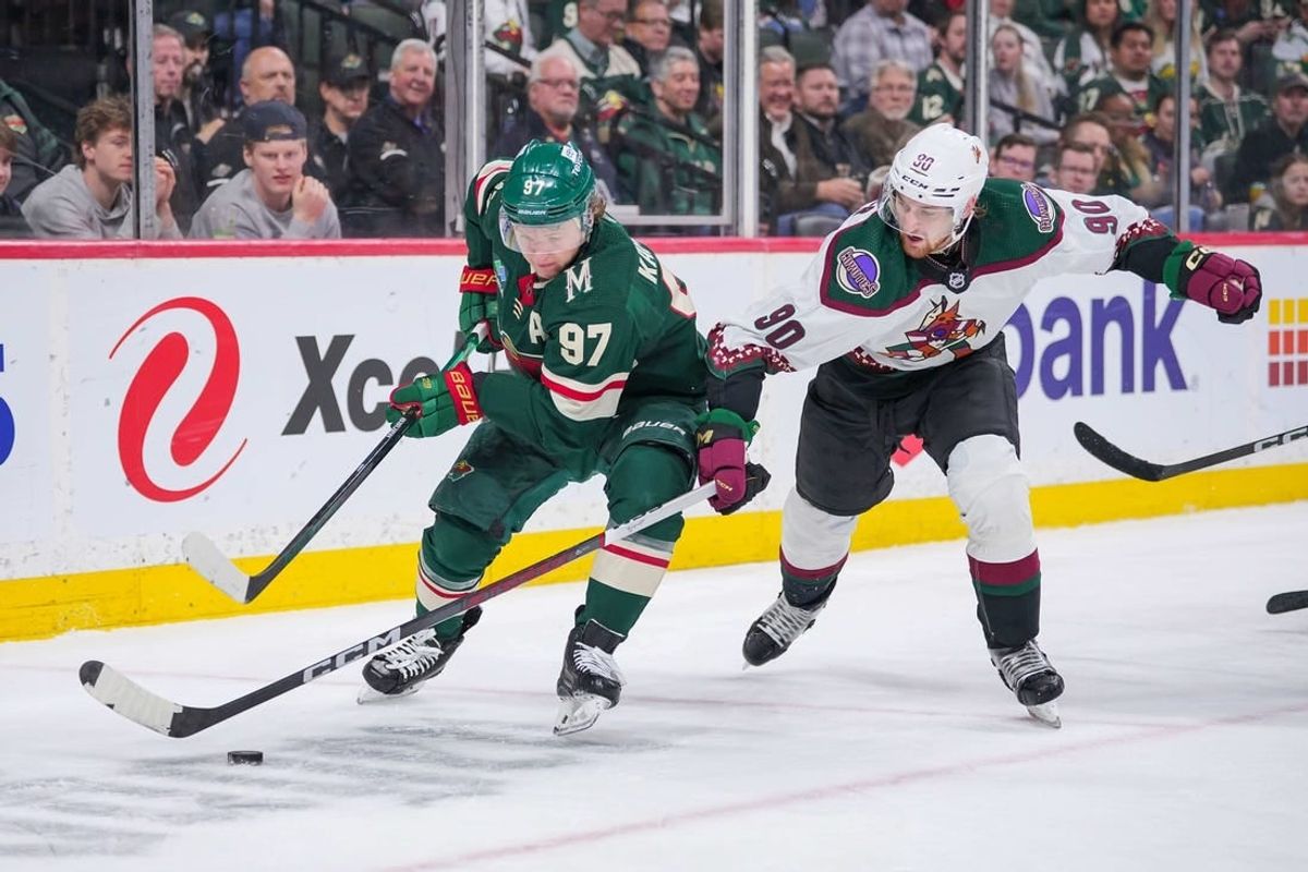 Mar 12, 2024; Saint Paul, Minnesota, USA; Minnesota Wild left wing Kirill Kaprizov (97) skates with the puck against the Arizona Coyotes defenseman J.J. Moser (90) in the second period at Xcel Energy Center.