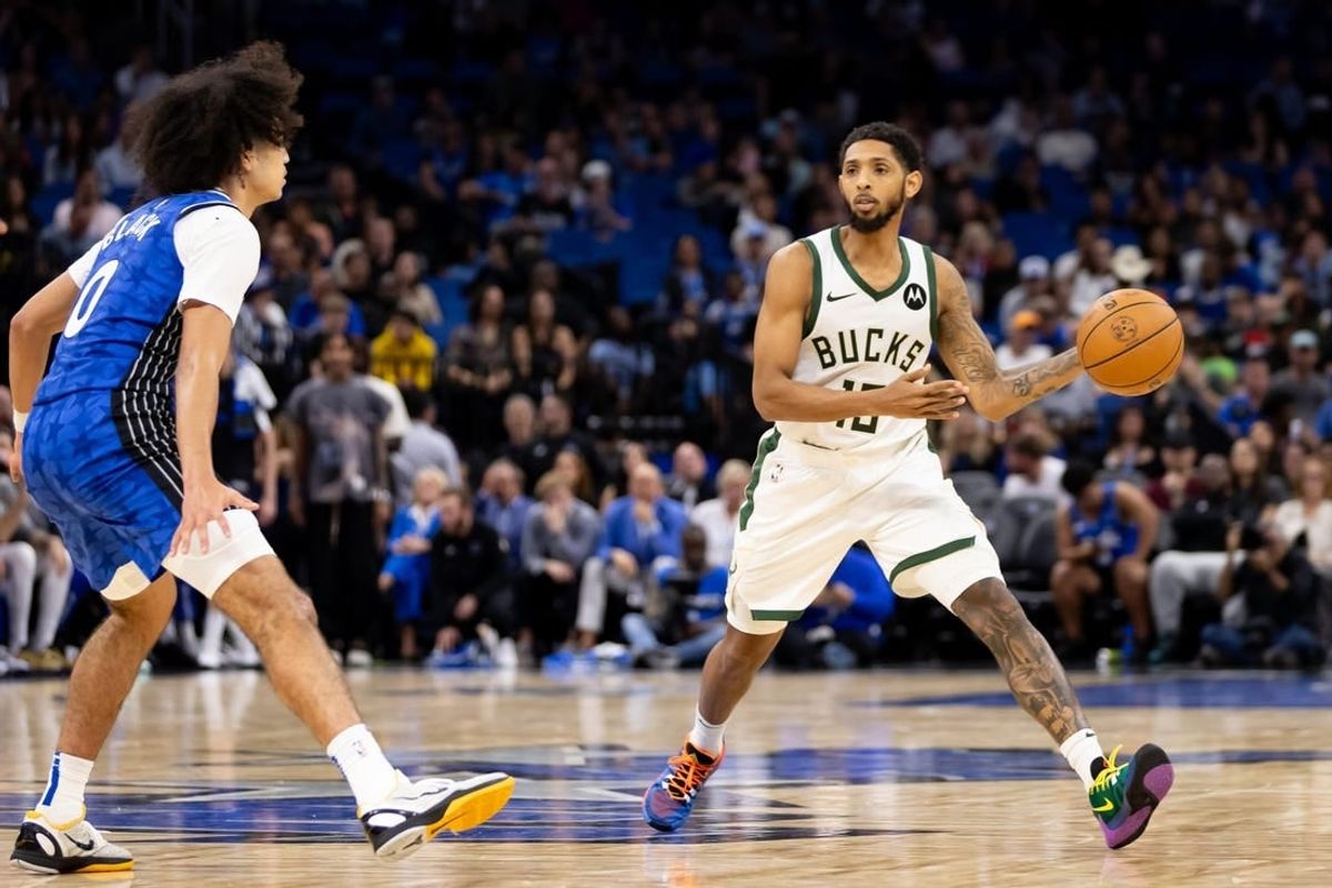 Nov 11, 2023; Orlando, Florida, USA; Milwaukee Bucks guard Cameron Payne (15) passes the ball past Orlando Magic guard Anthony Black (0) during the second half at Amway Center.