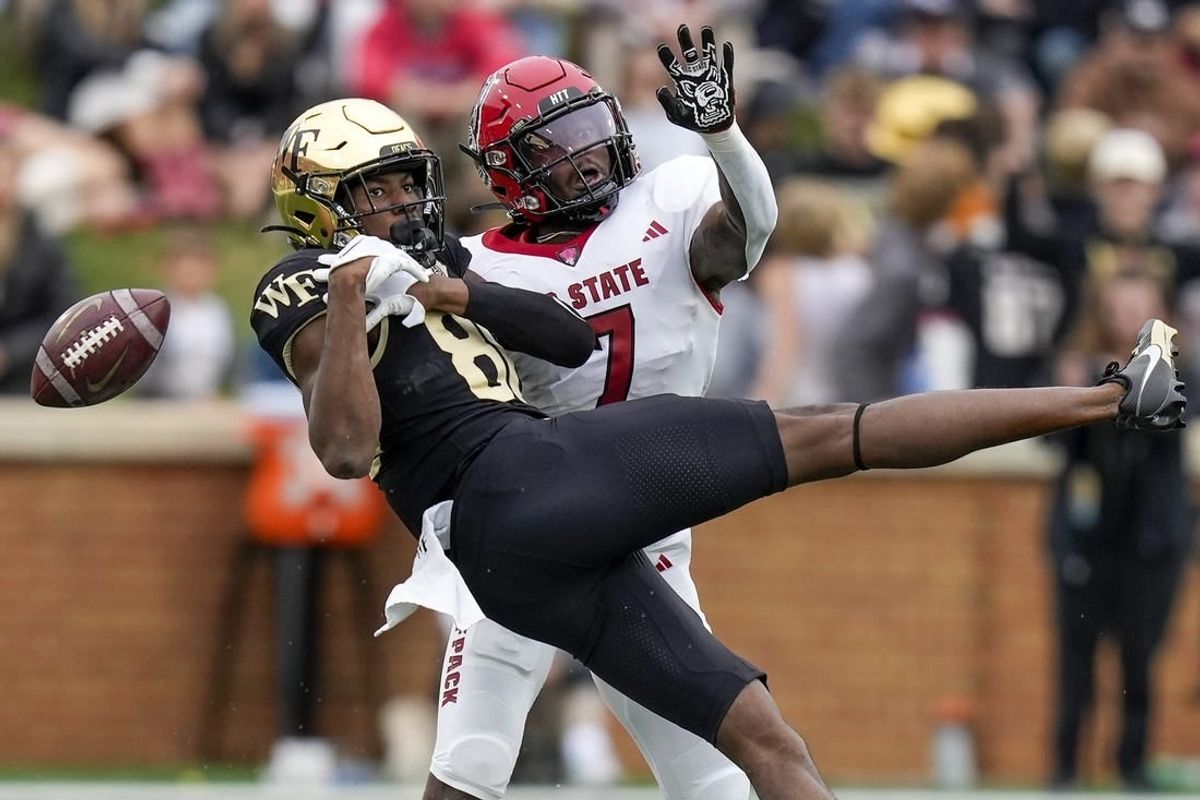 Nov 11, 2023; Winston-Salem, North Carolina, USA; Wake Forest Demon Deacons running back Justice Ellison (6) loses the ball defended by North Carolina State Wolfpack cornerback Shyheim Battle (7) during the first half at Allegacy Federal Credit Union Stadium.