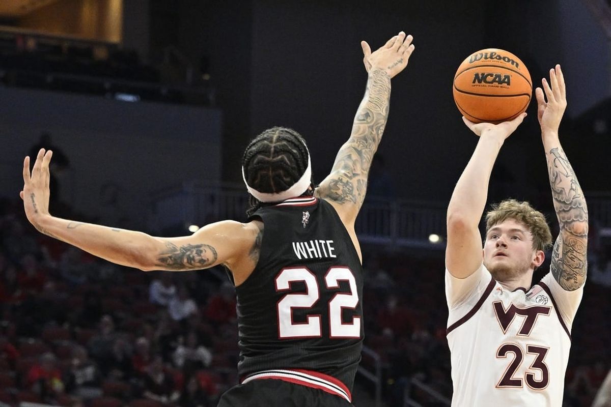 Mar 5, 2024; Louisville, Kentucky, USA; Virginia Tech Hokies guard Tyler Nickel (23) shoots against Louisville Cardinals guard Tre White (22) during the first half at KFC Yum! Center.