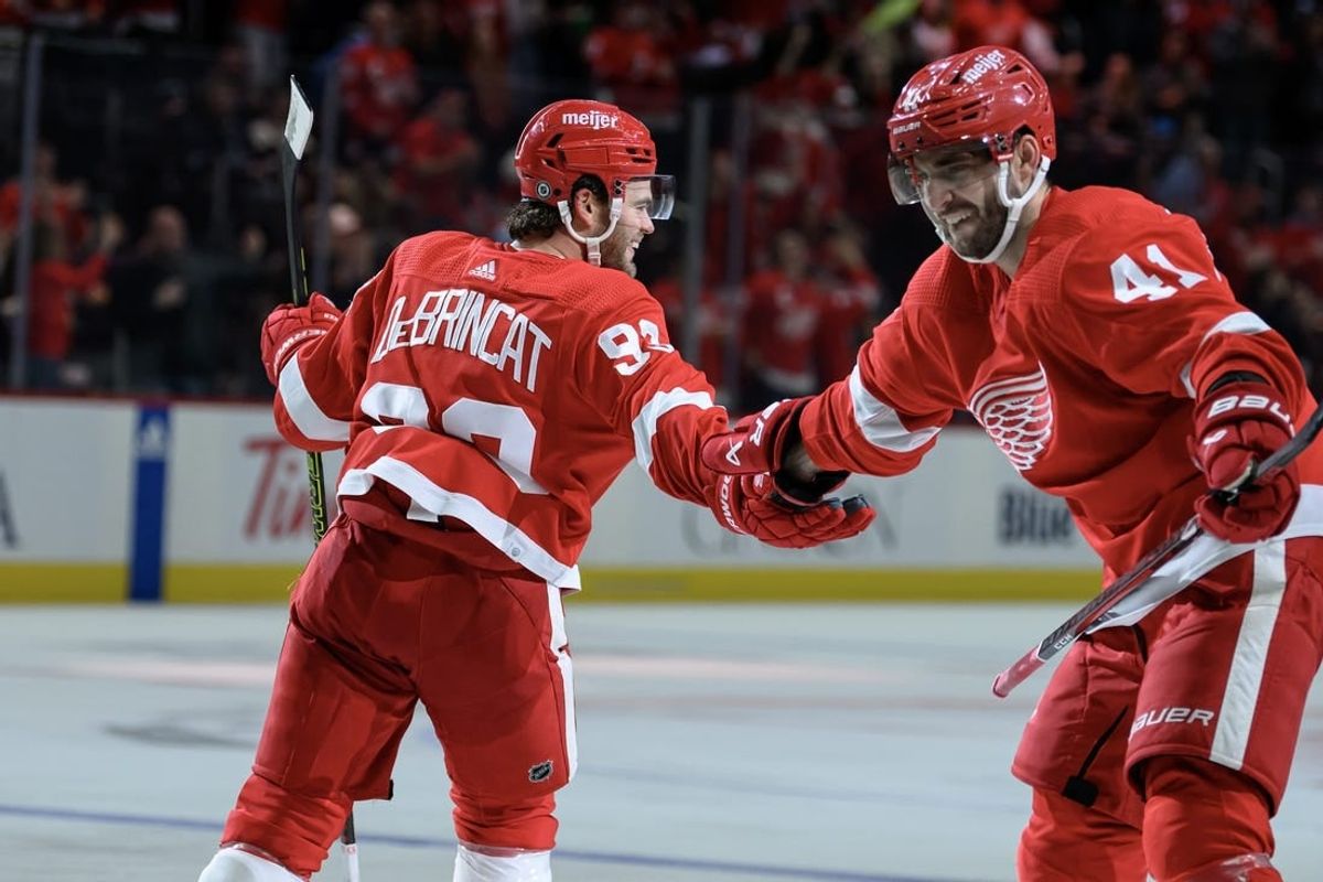Oct 24, 2023; Detroit, Michigan, USA; Detroit Red Wings right wing Alex DeBrincat (93) celebrates with defenseman Shayne Gostisbehere (41)after scoring a power play goal against the Seattle Kraken in the third period at Little Caesars Arena.