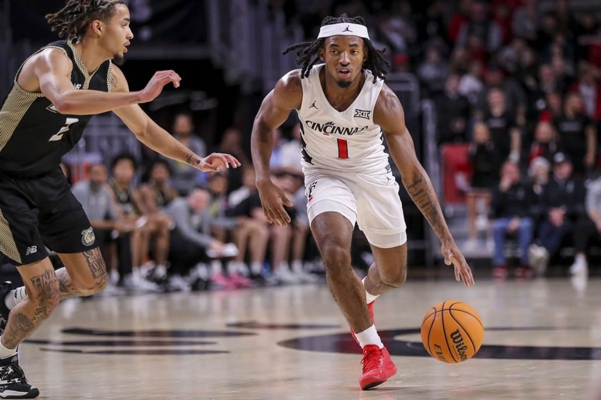 Dec 12, 2023; Cincinnati, Ohio, USA; Cincinnati Bearcats guard Day Day Thomas (1) dribbles against Bryant Bulldogs guard Tyler Brelsford (2) in the second half at Fifth Third Arena.