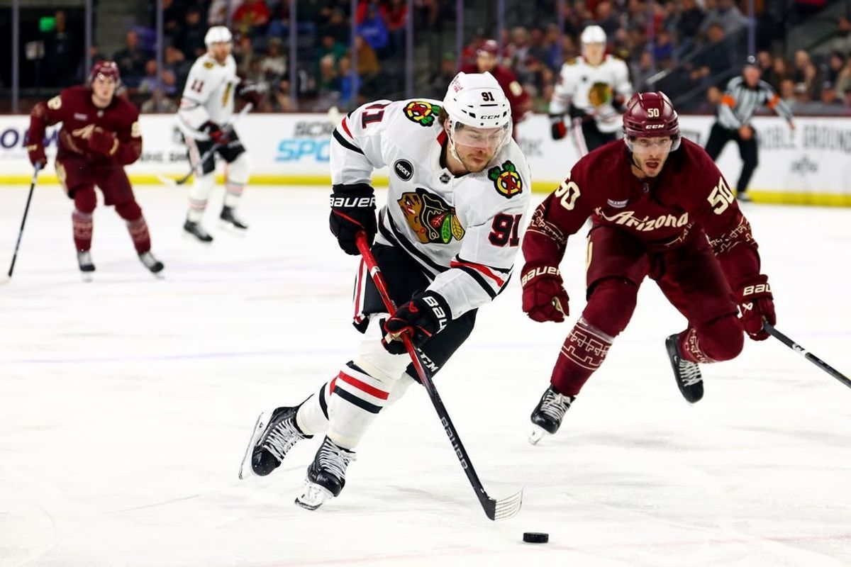 Mar 5, 2024; Tempe, Arizona, USA;  Chicago Blackhawks left wing Anthony Beauvillier (91) moves the puck against Arizona Coyotes defenseman Sean Durzi (50) during the third period at Mullett Arena.