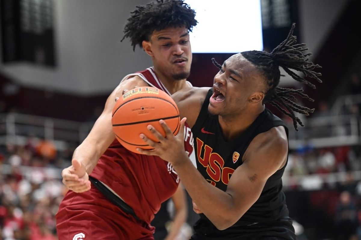 Feb 10, 2024; Stanford, California, USA; Stanford Cardinal forward Spencer Jones (14) defends against USC Trojans guard Isaiah Collier (1) during the first half at Maples Pavilion.