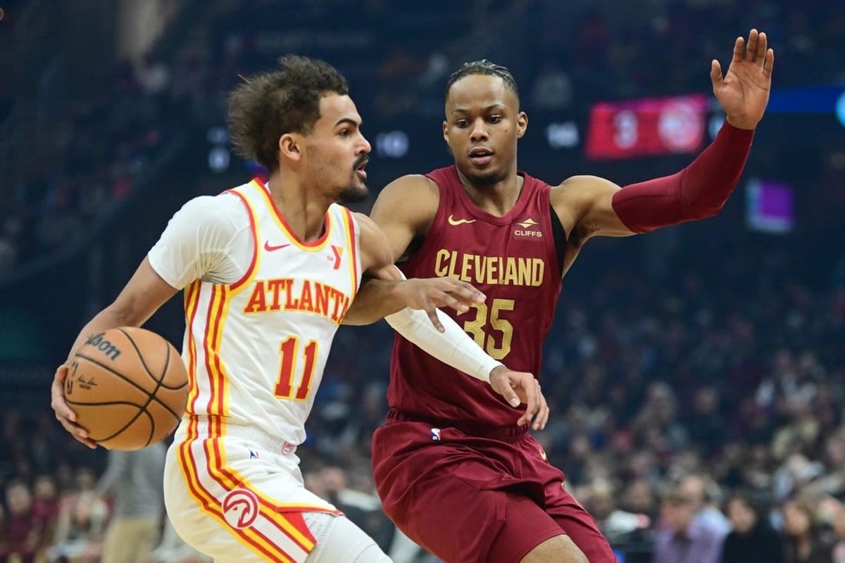 Dec 16, 2023; Cleveland, Ohio, USA; Atlanta Hawks guard Trae Young (11) drives to the basket against Cleveland Cavaliers forward Isaac Okoro (35) during the first quarter at Rocket Mortgage FieldHouse.