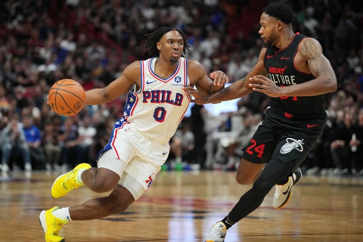 Apr 4, 2024; Miami, Florida, USA;  Philadelphia 76ers guard Tyrese Maxey (0) drives past Miami Heat forward Haywood Highsmith (24) during the second half at Kaseya Center.
