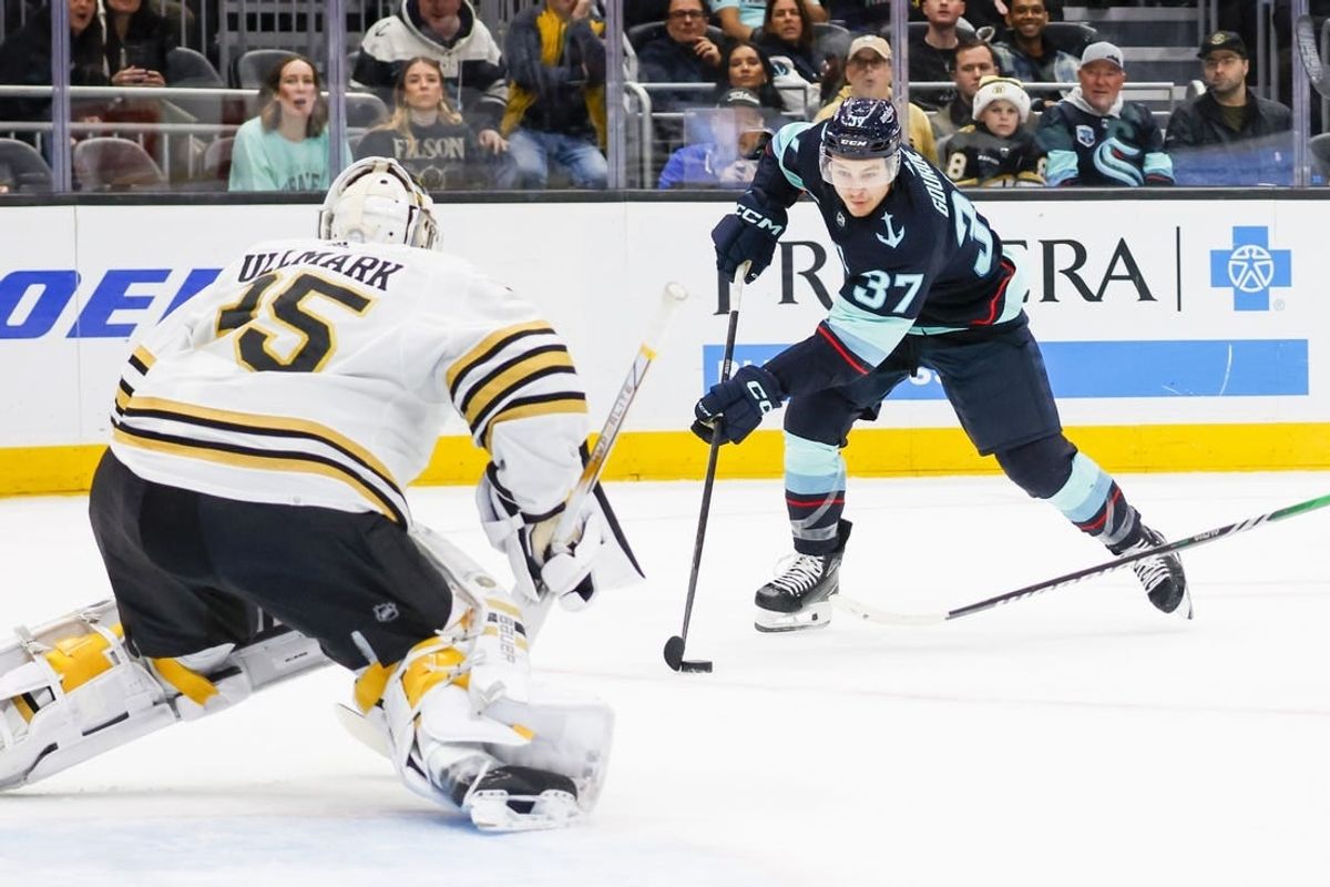 Feb 26, 2024; Seattle, Washington, USA; Seattle Kraken center Yanni Gourde (37) skates with the puck against the Boston Bruins during the first period at Climate Pledge Arena.