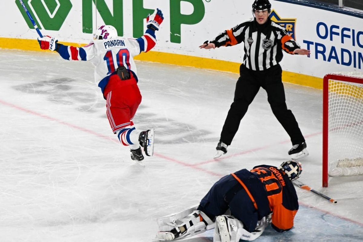 Feb 18, 2024; East Rutherford, New Jersey, USA;  New York Rangers left wing Artemi Panarin (10) celebrates his game winning goal against the New York Islanders during the overtime period in a Stadium Series ice hockey game at MetLife Stadium.