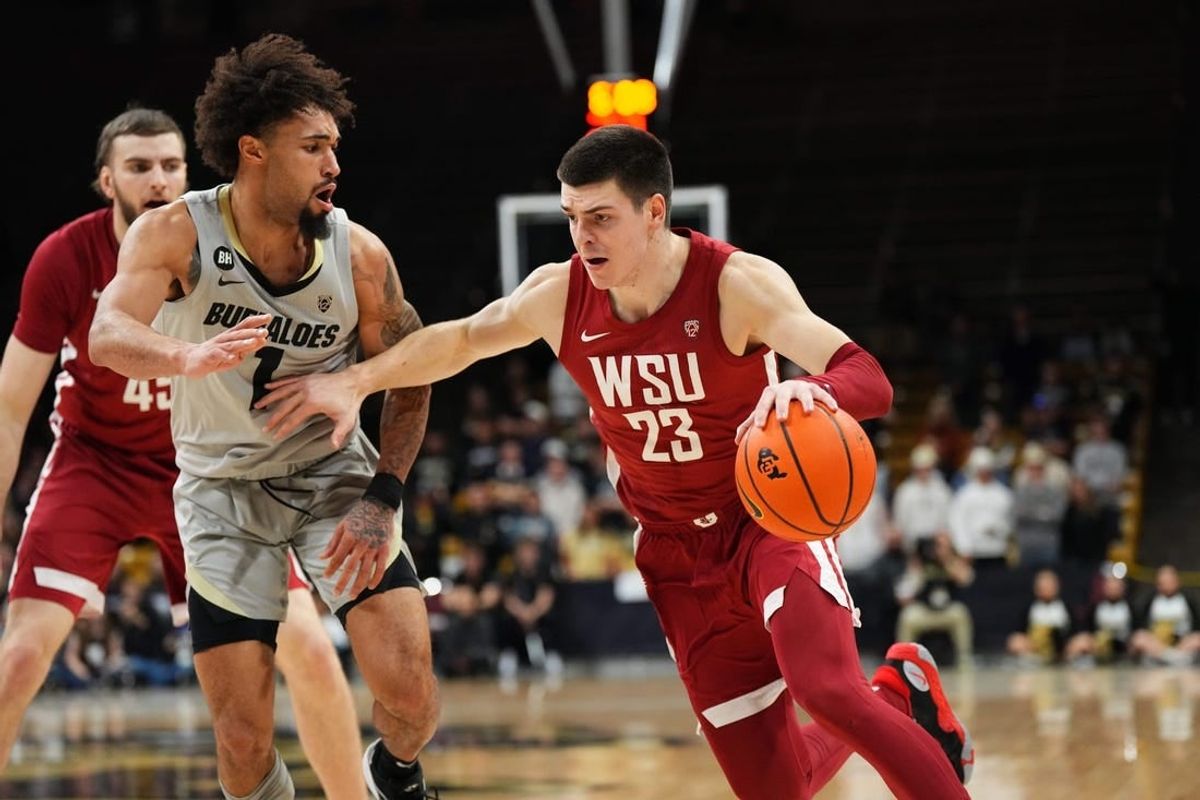 Dec 31, 2023; Boulder, Colorado, USA; Washington State Cougars forward Andrej Jakimovski (23) drives at Colorado Buffaloes guard J'Vonne Hadley (1)in the first half at the CU Events Center.