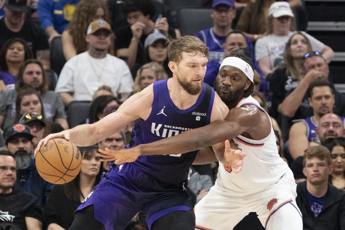 March 16, 2024; Sacramento, California, USA; Sacramento Kings forward Domantas Sabonis (10) dribbles the basketball against New York Knicks forward Precious Achiuwa (5) during the second quarter at Golden 1 Center.