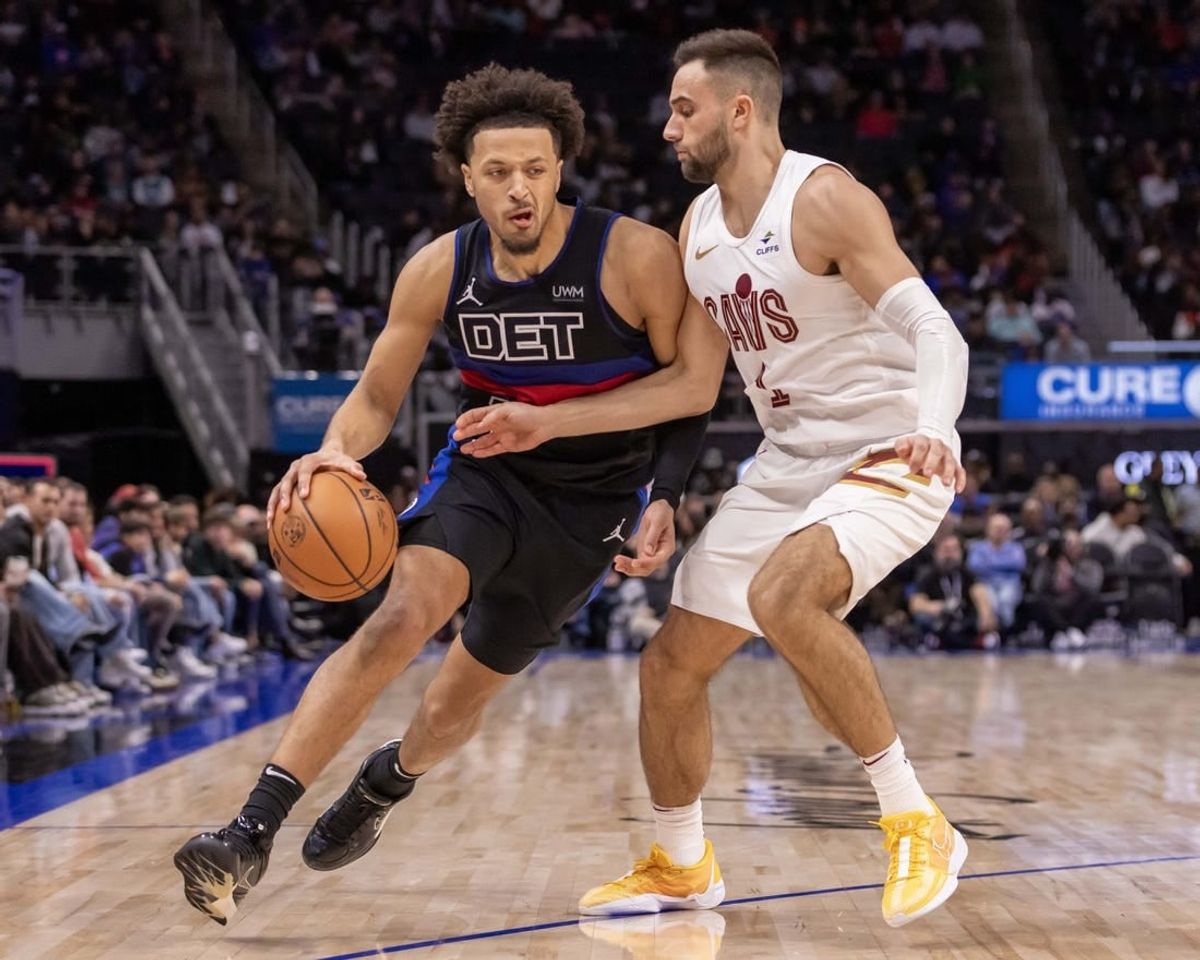 Dec 2, 2023; Detroit, Michigan, USA; Detroit Pistons guard Cade Cunningham (2) moves the ball up court as Cleveland Cavaliers guard Max Strus (1) defends during the second half at Little Caesars Arena.