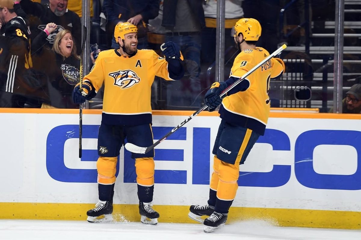 Apr 9, 2024; Nashville, Tennessee, USA; Nashville Predators center Ryan O'Reilly (90) celebrates with left wing Filip Forsberg (9) after a goal during the third period at Bridgestone Arena.