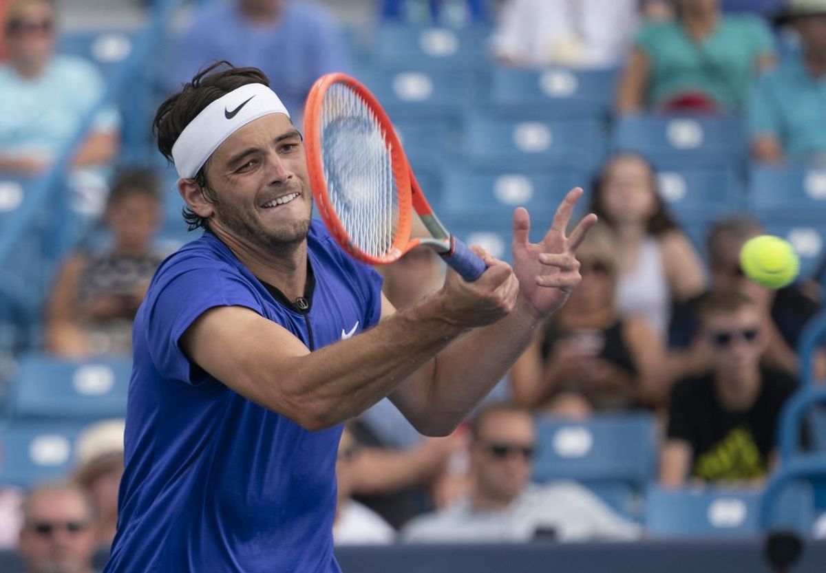 Aug 19, 2022; Cincinnati, OH, USA; Taylor Fritz (USA) returns a shot during his match against Daniil Medvedev (RUS) at the Western & Southern Open at the Lindner Family Tennis Center.