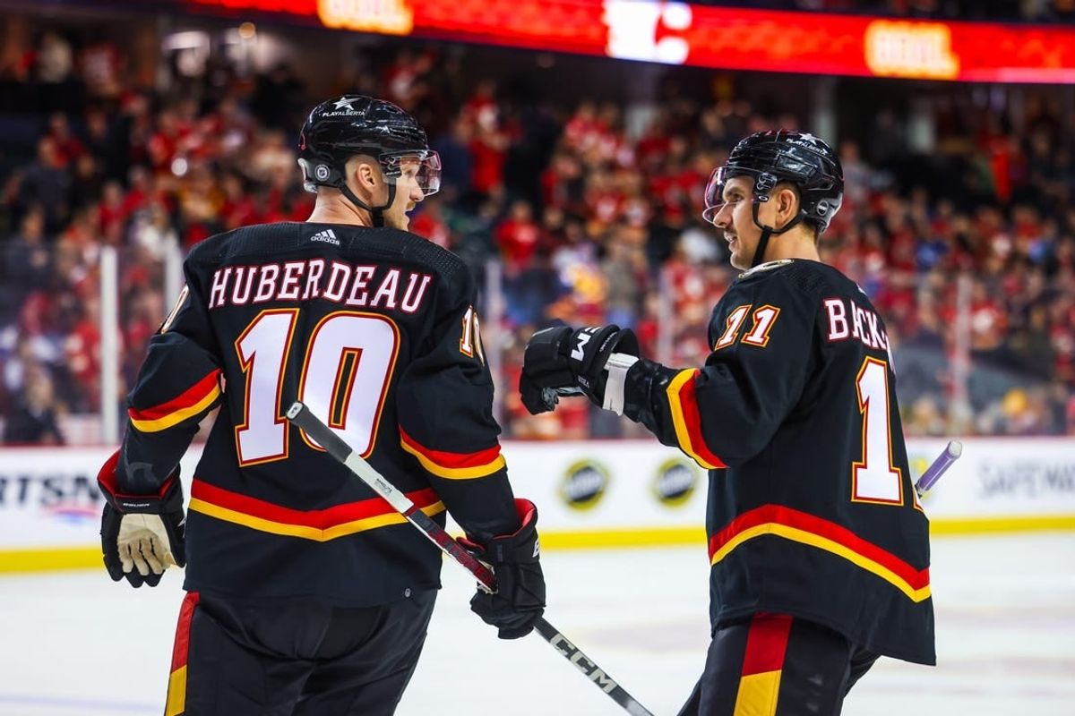 Nov 16, 2023; Calgary, Alberta, CAN; Calgary Flames center Jonathan Huberdeau (10) celebrates his goal with center Mikael Backlund (11) during the third period against the Vancouver Canucks at Scotiabank Saddledome.