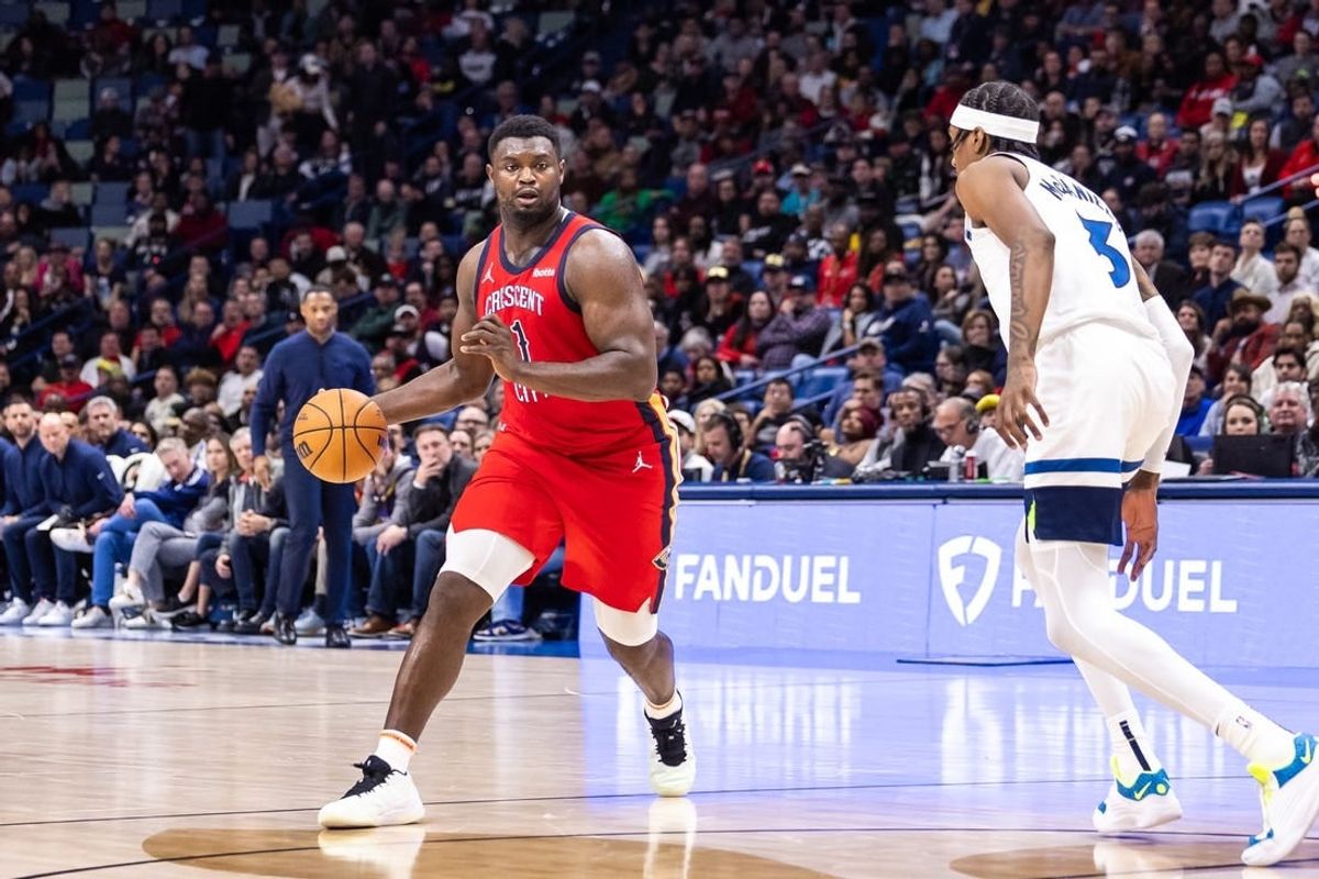 Dec 11, 2023; New Orleans, Louisiana, USA; New Orleans Pelicans forward Zion Williamson (1) dribbles against Minnesota Timberwolves forward Jaden McDaniels (3) during the second half at the Smoothie King Center.