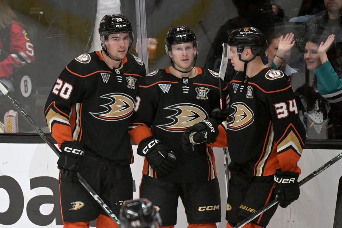Mar 21, 2024; Anaheim, California, USA;  Anaheim Ducks right wing Brett Leason (20) is congratulated by center Ben Meyers (39) and defenseman Pavel Mintyukov (34) after scoring a goal in the second period against the Chicago Blackhawks at Honda Center.