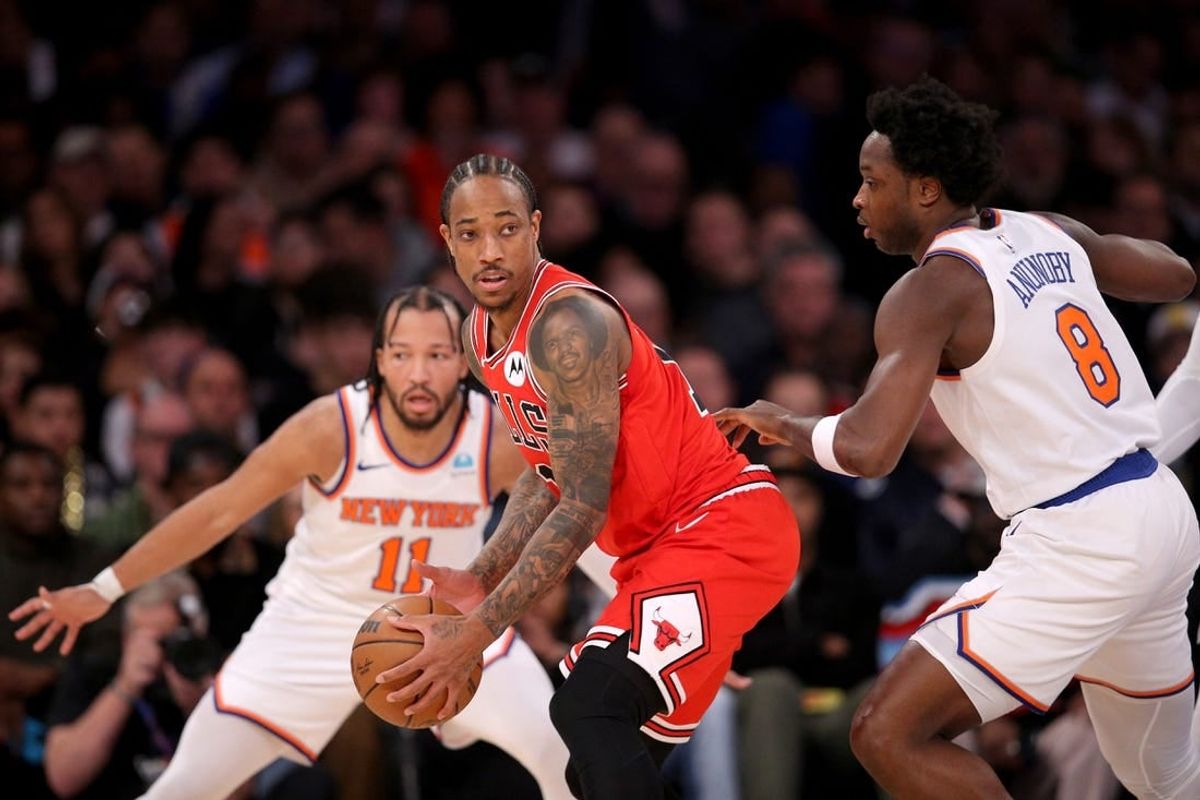 Jan 3, 2024; New York, New York, USA; Chicago Bulls forward DeMar DeRozan (11) controls the ball against New York Knicks guard Jalen Brunson (11) and forward OG Anunoby (8) during the second quarter at Madison Square Garden.