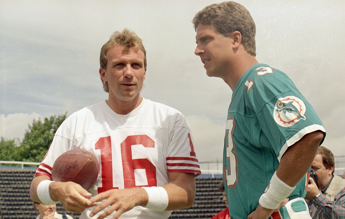 Joe Montana and Dan Marino were two of the biggest NFL stars in 1990. Marino ultimately signed over his marketing rights to the NFL, while Montana refused, but not out of solidarity with the NFLPA: he wanted a bigger cut than everybody else. (Photo credit: Doug Jennings/ [object Object] )