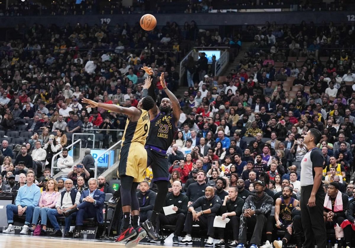 Apr 2, 2024; Toronto, Ontario, CAN; Los Angeles Lakers forward LeBron James (23) shoots the ball at the basket as Toronto Raptors guard RJ Barrett (9) tries to defend  during the second quarter at Scotiabank Arena.