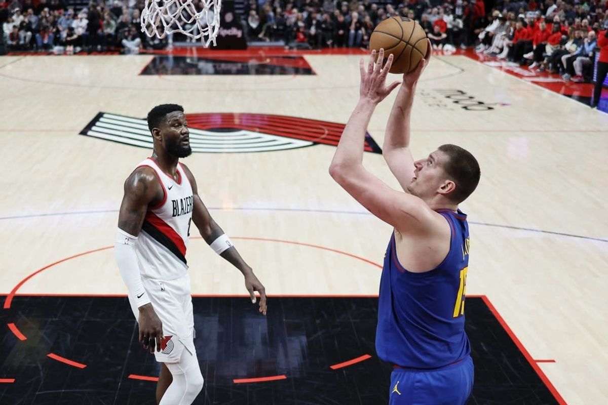 Feb 23, 2024; Portland, Oregon, USA; Denver Nuggets center Nikola Jokic (15) shoots the ball as Portland Trail Blazers center Deandre Anton (2) looks on during the first half at Moda Center.