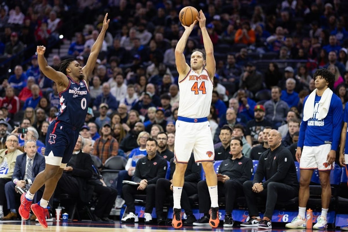 Feb 22, 2024; Philadelphia, Pennsylvania, USA; New York Knicks forward Bojan Bogdanovic (44) scores a three pointer in front of Philadelphia 76ers guard Tyrese Maxey (0) during the second quarter at Wells Fargo Center.