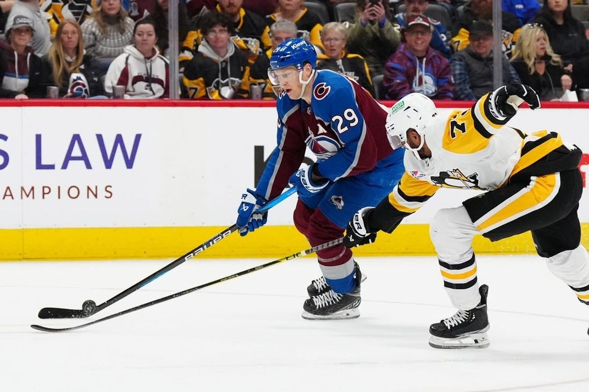 Mar 24, 2024; Denver, Colorado, USA; Pittsburgh Penguins defenseman Pierre-Olivier Joseph (73) defends on Colorado Avalanche center Nathan MacKinnon (29) in second period at Ball Arena.