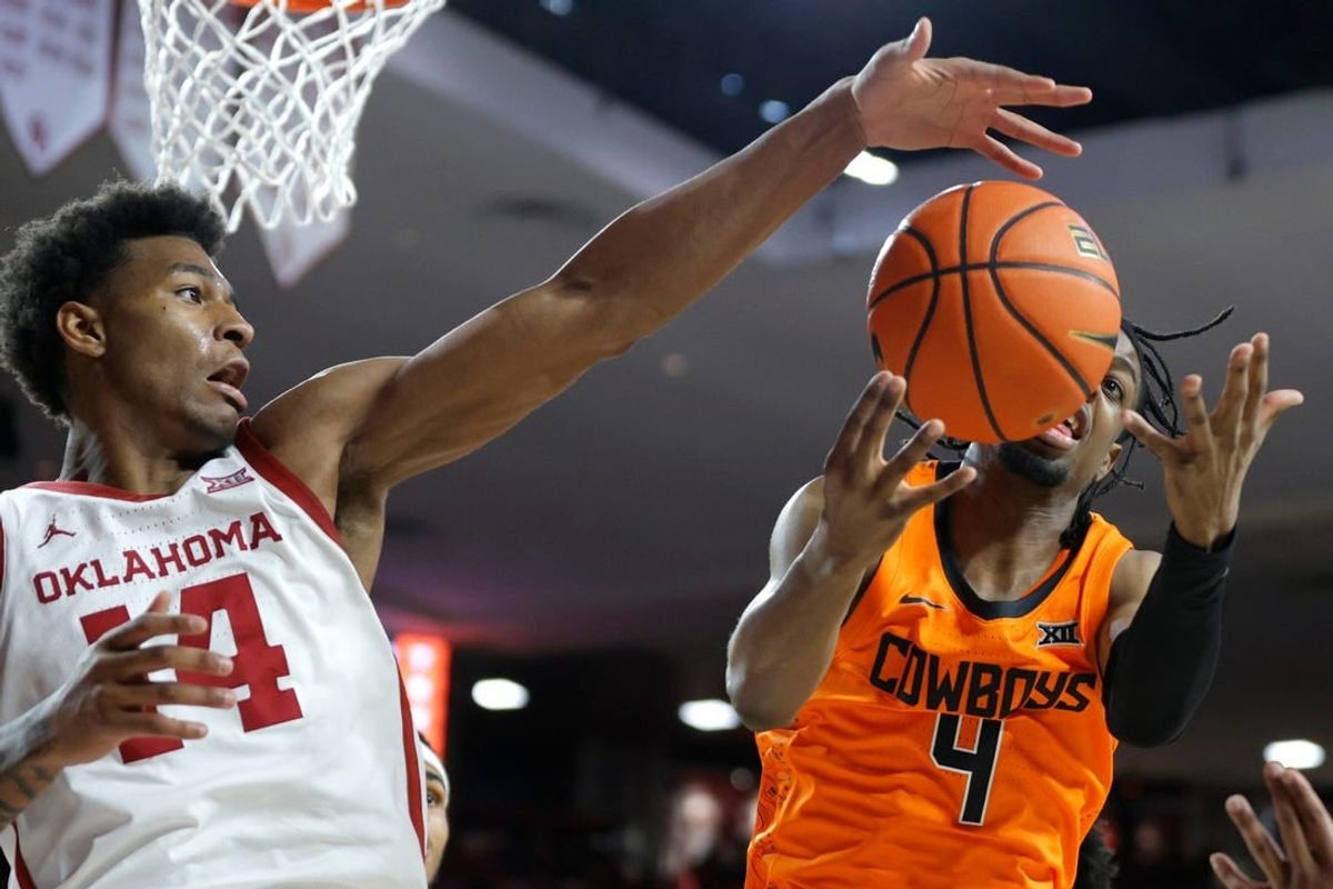 Oklahoma Sooners forward Jalon Moore (14) reaches for the ball beside Oklahoma State Cowboys guard Jarius Hicklen (4) during a Bedlam college basketball game between the University of Oklahoma Sooners (OU) and the Oklahoma State Cowboys (OSU) at Lloyd Noble Center in Norman, Okla., Saturday, Feb. 10, 2024.