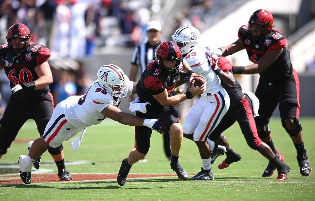 Sep 3, 2022; San Diego, California, USA; San Diego State Aztecs quarterback Braxton Burmeister (5) is tackled by Arizona Wildcats defensive lineman Tiaoalii Savea (98) during the second half at Snapdragon Stadium.