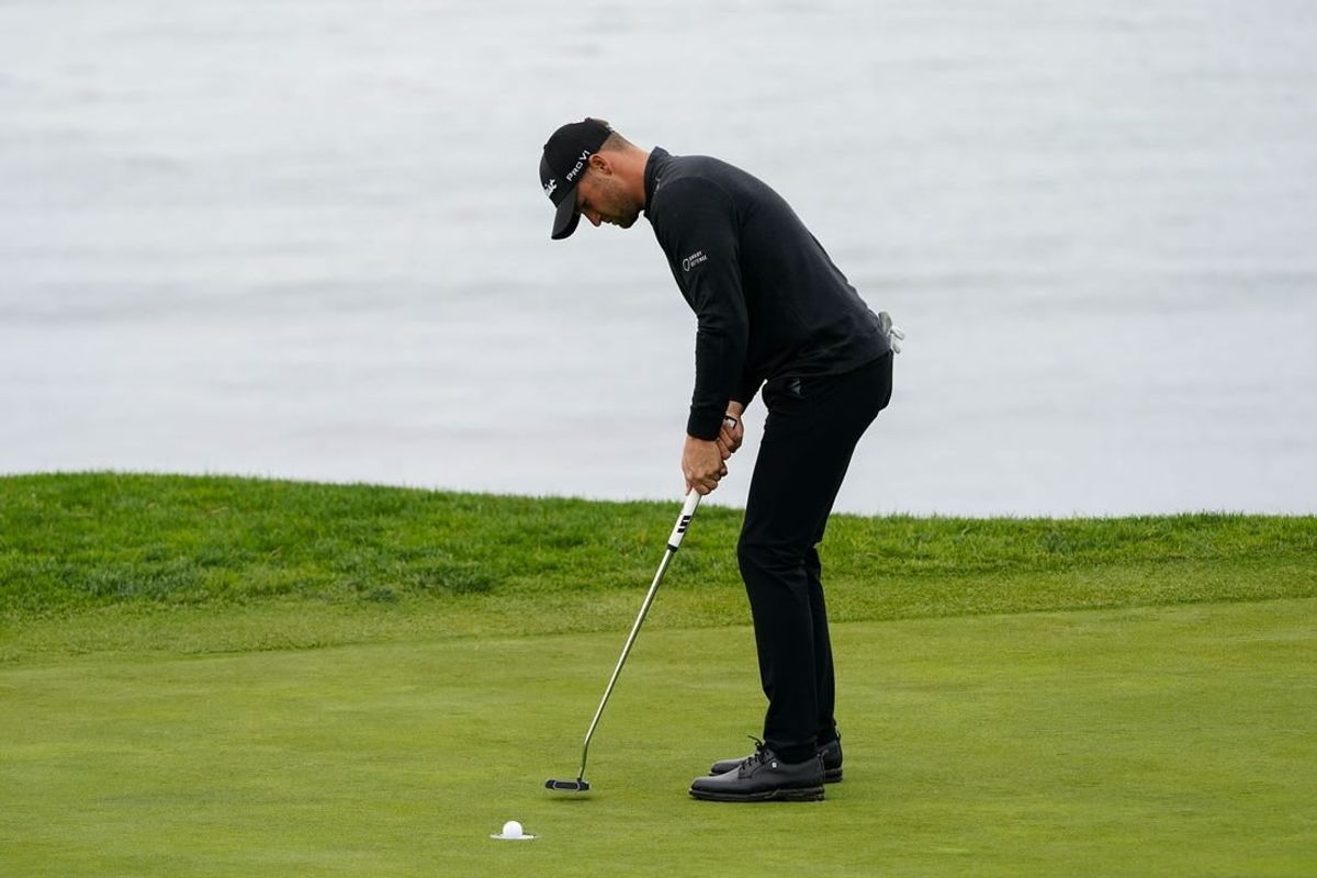 Feb 3, 2024; Pebble Beach, California, USA; Wyndham Clark putts on the fifth hole during the third round of the AT&T Pebble Beach Pro-Am golf tournament at Pebble Beach Golf Links.