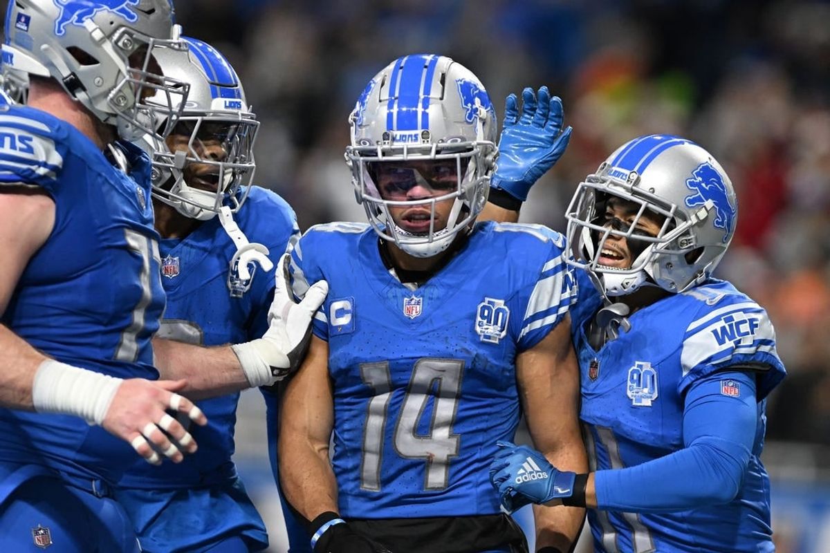 Dec 16, 2023; Detroit, Michigan, USA; Detroit Lions wide receiver Amon-Ra St. Brown (14) celebrates in the end zone with wide receiver Kalif Raymond (right) and wide receiver Jameson Williams (9) and center Frank Ragnow (left) after scoring a touchdown against the Denver Broncos in the second quarter at Ford Field.