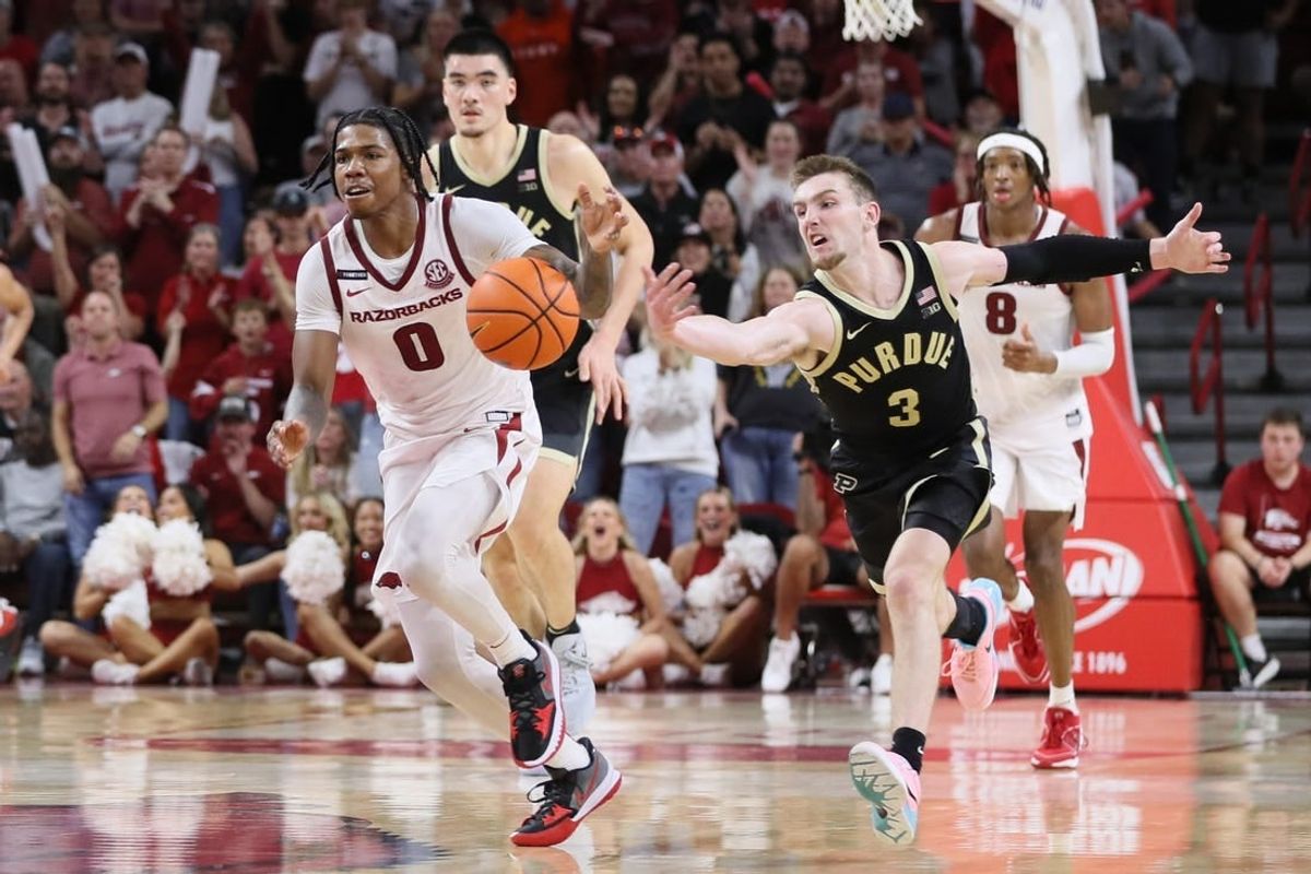 Oct 28, 2023; Fayetteville, AR, USA; Arkansas Razorbacks guard Khalif Battle (0) dribbles the ball against Purdue Boilermakers guard Braden Smith (3) on a fast break int he second half at Bud Walton Arena. Arkansas won 81-77.
