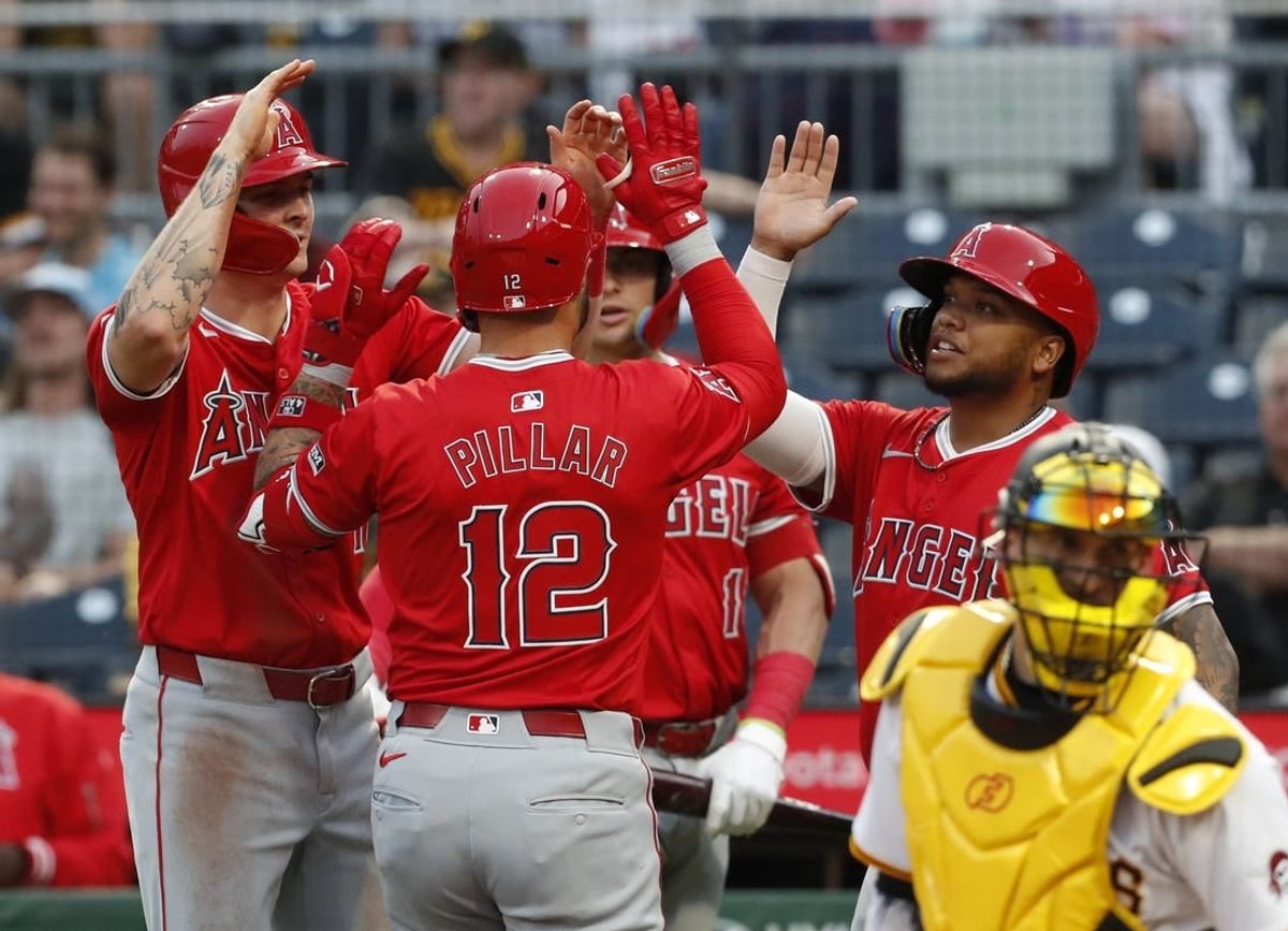 May 7, 2024; Pittsburgh, Pennsylvania, USA;  Los Angeles Angels Los Angeles Angels center fielder Mickey Moniak (left) and catcher Logan O'Hoppe (rear) and designated hitter Willie Calhoun (right) greet left fielder Kevin Pillar (12) crossing home plate on a three-run home run against the Pittsburgh Pirates during the fourth inning at PNC Park.