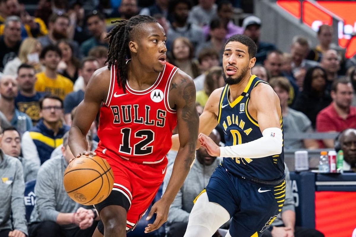 Mar 13, 2024; Indianapolis, Indiana, USA; Chicago Bulls guard Ayo Dosunmu (12) dribbles the ball while Indiana Pacers guard Tyrese Haliburton (0) defends in the first half at Gainbridge Fieldhouse.